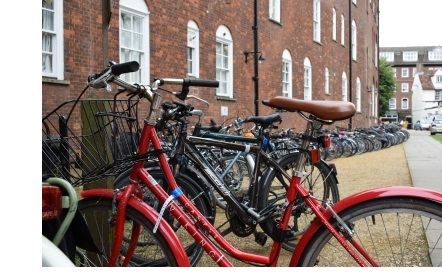 The bike rack in New Court at Christ's College, Cambridge, with a bright red bike in the foreground